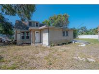 Cottage-style home featuring wood siding and an unkempt front yard ready for landscaping at 3258 Adrian Ave, Largo, FL 33774