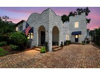 Charming two-story home with unique stucco exterior and brick driveway at 3405 W Palmira Ave, Tampa, FL 33629