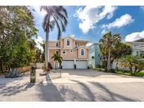Two-story, single Gathering home with a well-manicured lawn, 2-car garage, and tropical landscaping at 405 8Th N Ave, Tierra Verde, FL 33715