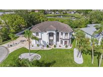 Expansive well maintained two-story home with manicured lawn and circular driveway at 4353 Dewey Dr, New Port Richey, FL 34652