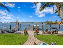 Waterfront backyard featuring a private boat dock, inviting lounge area, and lush landscaping at 4649 Neptune Se Dr, St Petersburg, FL 33705