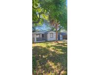 Cozy single-story home with a well-maintained front yard and mature trees at 9307 N 16Th St, Tampa, FL 33612