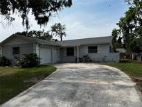 Charming single-story home with a spacious driveway and well-maintained landscaping at 103 Inwood Cir, Brandon, FL 33510