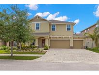 Charming two-story home with a three-car garage, landscaped yard, and a beautiful brick driveway at 10596 Lake Seminole Ter, Seminole, FL 33772