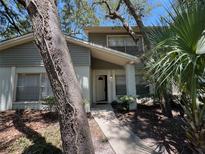 Inviting front entrance with a covered porch and lush landscaping creates an appealing curb appeal at 14667 Pine Glen Crk # 14667, Lutz, FL 33559