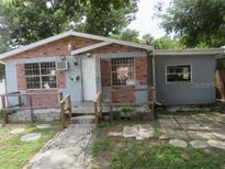 Modest one story home with brick facade, small front porch and green yard in need of TLC at 1785 42Nd S St, St Petersburg, FL 33711