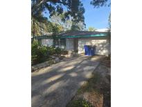 Charming single-story home with a private driveway and an attached garage at 1831 Pasadena Dr, Dunedin, FL 34698