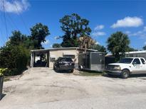 Modest single story home with a carport and simple landscaping on a sunny day at 6591 50Th N St, Pinellas Park, FL 33781