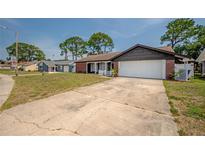 Charming single-Gathering home with an attached two-car garage and a well-manicured lawn at 4435 Sail Dr, New Port Richey, FL 34652