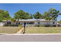 Charming single-story home with a well-manicured lawn and decorative privacy wall at 5201 108Th N St, St Petersburg, FL 33708