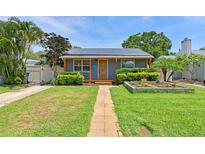 Charming single-story home with solar panels, walkway and inviting front garden at 6183 5Th S Ave, St Petersburg, FL 33707