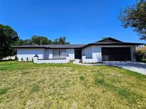 Well maintained single-story home featuring a neatly landscaped front yard and attached garage at 1178 Sultana St, Port Charlotte, FL 33952
