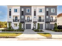 Modern townhomes featuring neutral exteriors, balconies and well-manicured landscaping at 1529 N Morgan St, Tampa, FL 33602