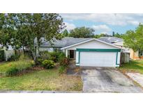 Charming single Gathering home with a two car garage, mature trees, and lush landscaping at 21608 Wytheville Way, Lutz, FL 33549