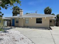 Charming single-story home with light-colored paint, chimney, and a well-maintained front yard at 3207 S De Bazan Ave, St Pete Beach, FL 33706