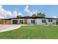 Charming single-story home boasting a manicured lawn and modern architectural details at 323 48Th Nw St, Bradenton, FL 34209