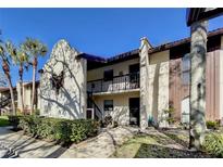Two-story condo with a well-maintained landscape and walkway leading to the entrance at 3505 Tarpon Woods Blvd # I407, Palm Harbor, FL 34685