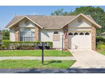 Charming single-story home featuring well-maintained landscaping, a one-car garage, and a welcoming facade at 4655 Wallingford Ct # 4655, New Port Richey, FL 34655