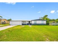 Charming single-story home featuring a well-maintained lawn and a freshly painted exterior at 5109 Horton Rd, Plant City, FL 33567