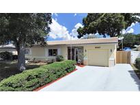 Charming home with manicured front yard, stone accents, and a light-colored tile roof at 6067 43Rd N Ter, Kenneth City, FL 33709