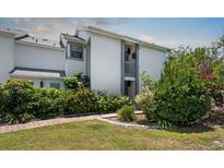 Inviting exterior of a two-story home with a well-manicured lawn and mature landscaping at 609 Lively Dr # B, Sun City Center, FL 33573