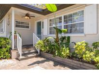 Charming home featuring a quaint front entrance with tropical plants and a stylish brick paver walkway at 6114 7Th S Ave, Gulfport, FL 33707