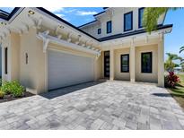 Beautiful home exterior featuring a spacious driveway and a modern design with architectural details at 6522 Simone Shores Cir, Apollo Beach, FL 33572