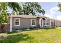 Beautiful single-story home with a green lawn and mature trees at 8517 N Branch Ave, Tampa, FL 33604