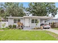 Charming single-story home with a well-manicured lawn, carport and inviting front entrance at 1015 13Th Nw Ave, Largo, FL 33770