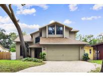 Charming tan two-story home with large windows and well-maintained landscaping for great curb appeal at 1139 43Rd N Ave, St Petersburg, FL 33703