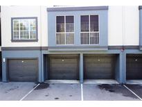 View of condo garages and second story patio that offers convenient parking and outdoor space at 13235 Sanctuary Cove Dr # 201, Temple Terrace, FL 33637