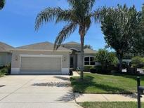 Charming single-story home features a well-manicured lawn and a spacious two-car garage, perfect for suburban living at 14711 Potterton Cir, Hudson, FL 34667