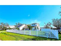 Charming two-story home featuring solar panels and a beautiful white picket fence at 1608 20Th W Ave, Palmetto, FL 34221