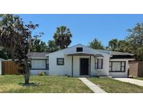 Charming single-story home featuring a well-maintained lawn and inviting front entrance at 1762 Fulton Ave, Clearwater, FL 33755