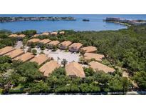 Stunning aerial view of waterfront homes surrounded by lush greenery with boat docks and scenic water views at 191 Banyan Bay Dr, St Petersburg, FL 33705