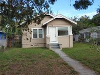 Charming home featuring a well-manicured lawn, inviting entryway, and a classic, neutral color palette at 1924 30Th S St, St Petersburg, FL 33712