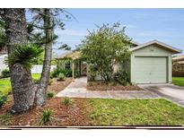 Charming single-story home with a well-manicured lawn and attached one-car garage at 204 Lake Charles Ct, Oldsmar, FL 34677