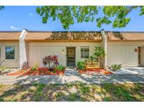 Charming townhome with a cozy front porch, garden bed, and a well-maintained yard at 2928 Feather Dr, Clearwater, FL 33759