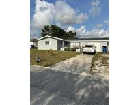 Charming single-story home featuring a well-maintained lawn and a paved driveway leading to an attached garage at 3612 Devonshire Dr, Holiday, FL 34691