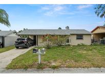 Charming single-story home with a well-maintained lawn and mature landscaping at 4150 Pecos Dr, New Port Richey, FL 34653