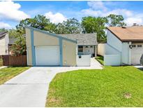 Charming single-Gathering home featuring an attached garage, well-manicured lawn, and inviting curb appeal at 12516 Cobble Stone Dr, Hudson, FL 34667