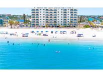Aerial view of the beach featuring white sand and turquoise water at this beachside condo complex at 13500 Gulf Blvd # 506, Madeira Beach, FL 33708