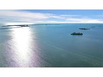 Scenic aerial view featuring calm waters and distant islands under a bright, partly cloudy sky at 2700 Bayshore Blvd # 11308, Dunedin, FL 34698