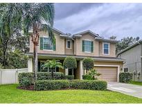Charming two-story home with a well-manicured lawn and verdant landscaping at 3544 Brook Crossing Dr, Brandon, FL 33511