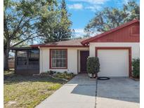 Charming single-story home with a manicured lawn and a screened-in porch, perfect for enjoying the outdoors at 3705 Simpson Ct, Palm Harbor, FL 34684