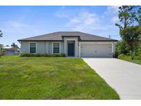 Charming single-story home with a well-manicured lawn and a neutral-colored facade at 4831 Hillman Ter, North Port, FL 34288