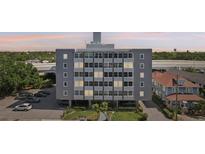 Multi-story Suncoast Towers building featuring a gray exterior, ample windows, and covered parking at 841 4Th N Ave # 55, St Petersburg, FL 33701
