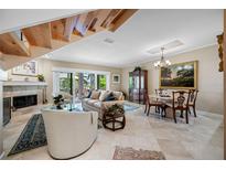 Bright living room with marble floors, fireplace, and staircase leading to the second floor at 903 Pinellas Bayway S # 103, Tierra Verde, FL 33715