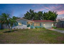 Charming single-story home featuring a red tile roof, an attached garage and a landscaped front yard at 9952 111Th St, Seminole, FL 33772