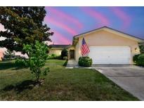 Charming single-story home with a manicured lawn and an attached two-car garage at 11746 93Rd Ave, Seminole, FL 33772